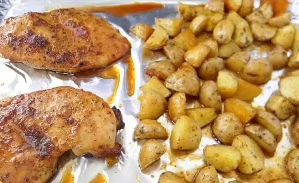 Sheet pan with honey glazed chicken and potatoes ready to serve