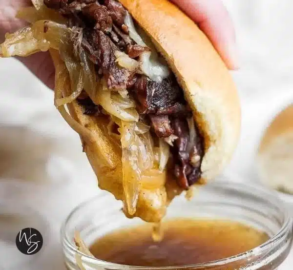 Slow Cooker French Dip Sandwiches served on a platter with dipping sauce