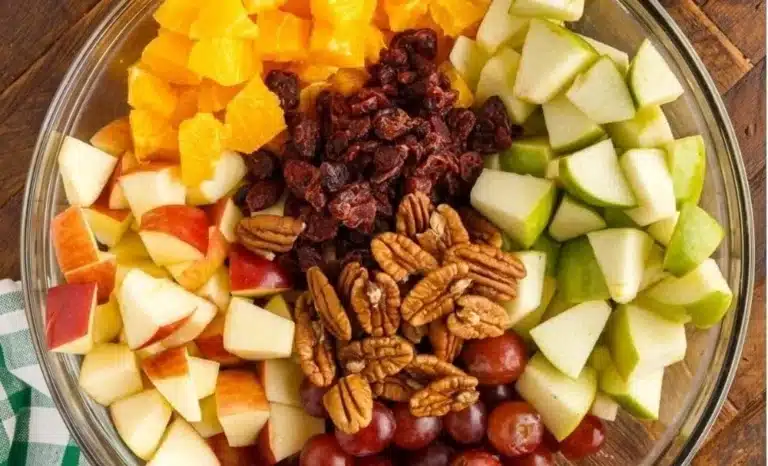 Apple fruit salad with warm fall spice dressing in a bowl.