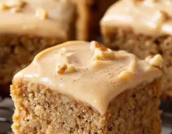 Delicious banana bread brownies topped with nuts and chocolate.