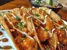Crispy chicken wonton tacos garnished with fresh toppings