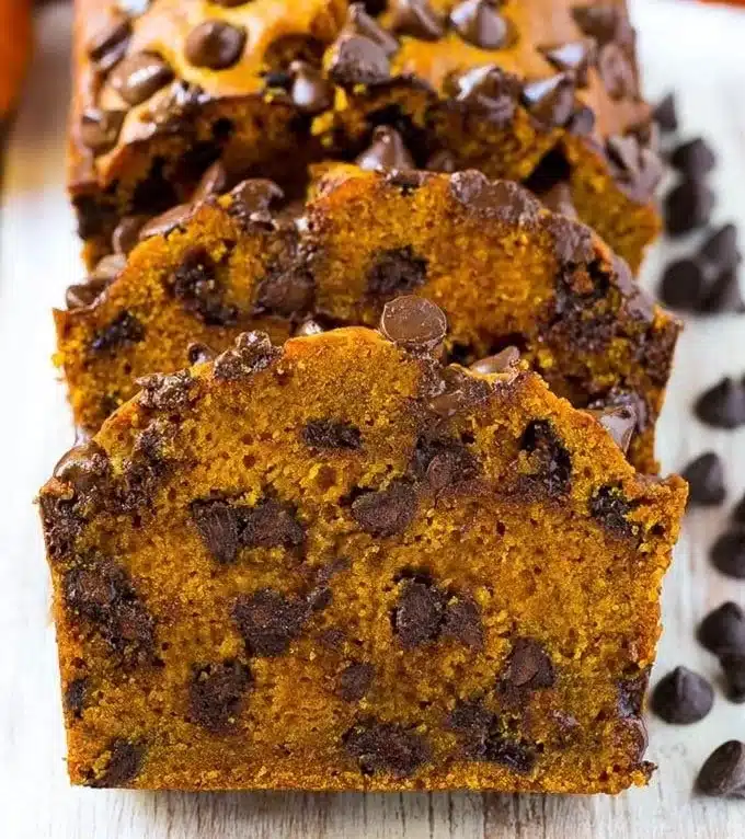 Delicious slice of chocolate chip pumpkin bread on a wooden table