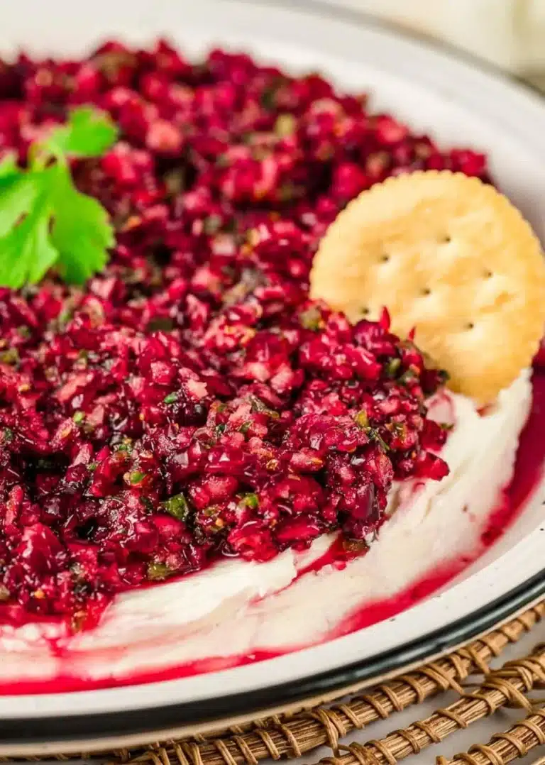 Cranberry Jalapeno Cream Cheese Dip served in a bowl with crackers