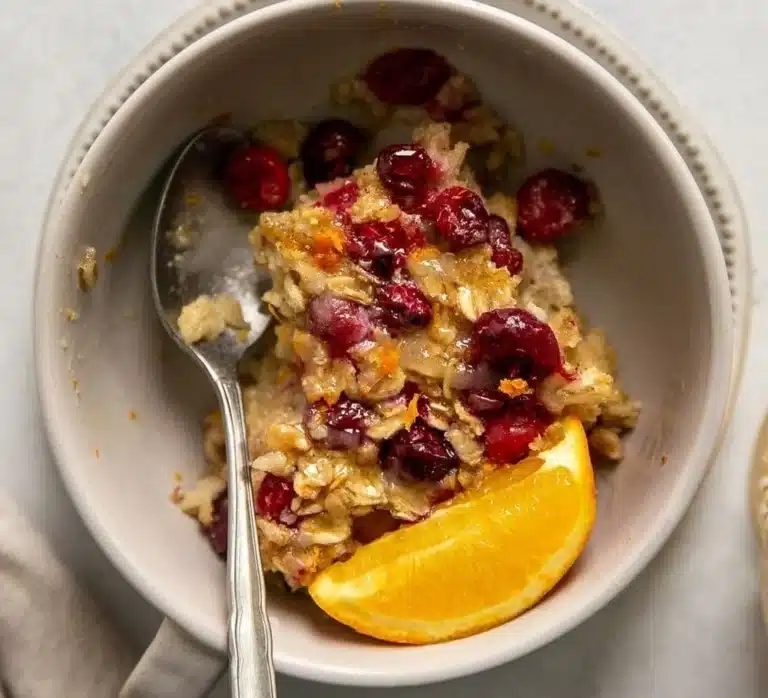 Healthy cranberry orange baked oatmeal dish in a rustic bowl