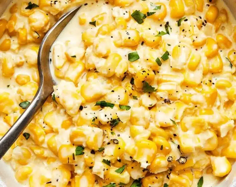 Creamed corn served as a traditional Thanksgiving side dish in a white bowl