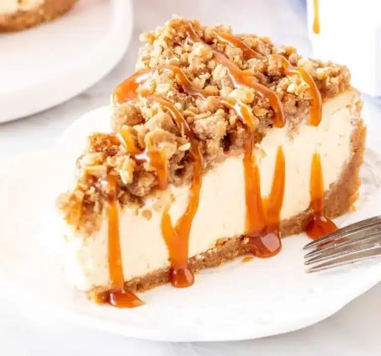 Slice of easy apple crisp cheesecake topped with crunchy oats and apples