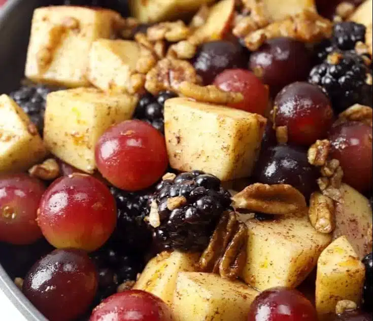 Fall fruit salad with cinnamon orange dressing on a table