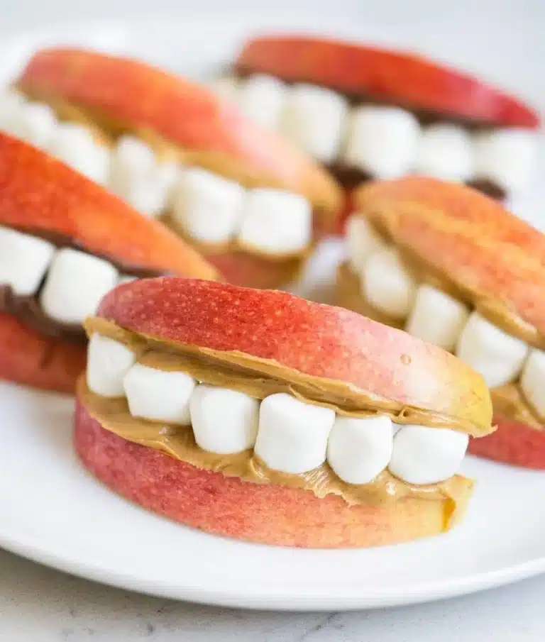 Colorful and healthy Halloween snacks for kids, featuring fruits and veggies.