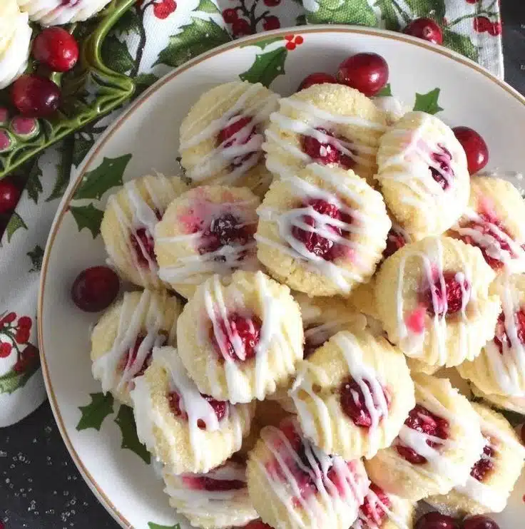 Lemon Cranberry Cookies on a plate with a drizzle of lemon glaze.