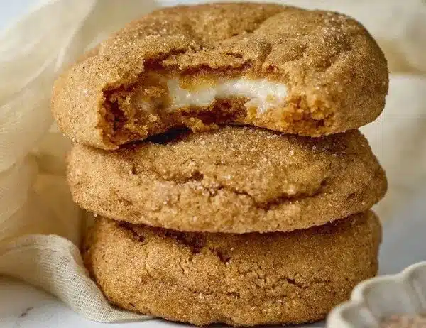 Delicious pumpkin cheesecake cookies on a plate, garnished with autumn spices.