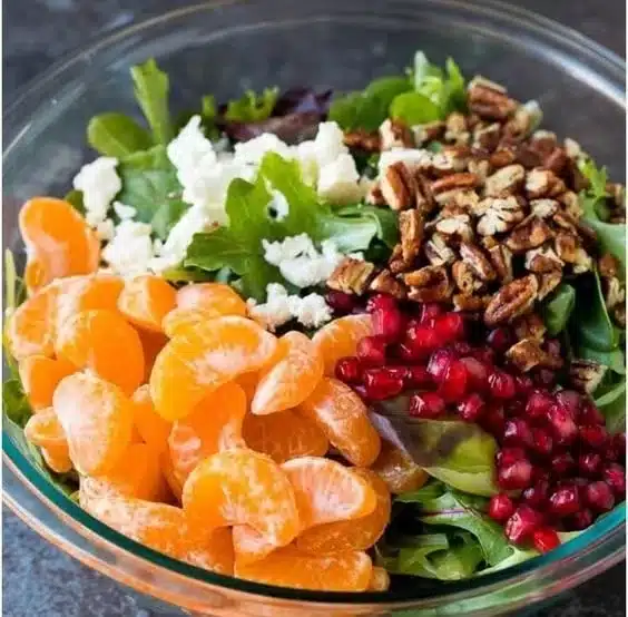 Colorful winter salad with seasonal vegetables and fruits.